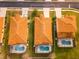 An aerial shot of three homes, each featuring a private, screened-in pool and terra cotta tiled roofs at 2610 Rosemont Cir, Davenport, FL 33837