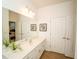 Bathroom featuring a white vanity, decorative art and two doors at 2610 Rosemont Cir, Davenport, FL 33837