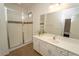 Bright bathroom featuring a glass-enclosed shower and a white vanity with a large mirror at 2610 Rosemont Cir, Davenport, FL 33837