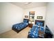 Bright bedroom with twin beds, white walls, and natural light streaming through the windows at 2610 Rosemont Cir, Davenport, FL 33837