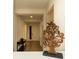 Hallway featuring a decorative tree sculpture, table, and view of the front door at 2610 Rosemont Cir, Davenport, FL 33837