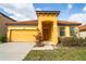 Charming yellow home featuring a tile roof, well-manicured lawn, and a welcoming front porch at 2610 Rosemont Cir, Davenport, FL 33837