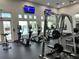 Interior of the gym featuring modern equipment and large windows overlooking the community pool at 2610 Rosemont Cir, Davenport, FL 33837