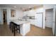 Kitchen featuring a large island with seating, white cabinets and appliances, and tile flooring at 2610 Rosemont Cir, Davenport, FL 33837