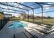 Enclosed pool area with -safety fence and lots of patio furniture at 2610 Rosemont Cir, Davenport, FL 33837