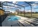 Enclosed pool area with -safety fence and lots of patio furniture at 2610 Rosemont Cir, Davenport, FL 33837