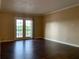 Living room featuring dark laminate floors and sliding glass doors to the balcony at 285 Wymore Rd # 204, Altamonte Springs, FL 32714