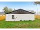 Backyard of a home with a view of the side of the property, showing a fenced yard and satellite dish at 304 Dover St, Orlando, FL 32811