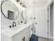 Bright bathroom featuring double sinks, modern fixtures, and stylish round mirrors at 304 Dover St, Orlando, FL 32811