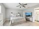 Bright bedroom with neutral walls, wood-look floors, a ceiling fan, and decorative wall sconces at 304 Dover St, Orlando, FL 32811