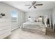 Bright bedroom with neutral walls, wood-look floors, a ceiling fan, and a window view at 304 Dover St, Orlando, FL 32811