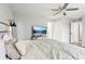 Neutral bedroom features wood-look floors, a ceiling fan, and a TV stand at 304 Dover St, Orlando, FL 32811