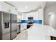 Modern kitchen featuring white cabinets, stainless steel appliances, blue backsplash, and an island at 304 Dover St, Orlando, FL 32811