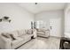 Bright living room with neutral tones, vaulted ceilings, and wood-look floors at 304 Dover St, Orlando, FL 32811