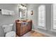 Well-lit powder room featuring a decorative mirror, and a stylish vanity at 314 Muirfield Loop, Reunion, FL 34747