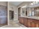 Elegant bathroom with granite countertops, dual sinks, and a walk-in shower at 314 Muirfield Loop, Reunion, FL 34747