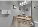 Elegant bathroom featuring a large mirror, granite countertops, and white cabinetry at 314 Muirfield Loop, Reunion, FL 34747