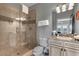 Updated bathroom with glass enclosed shower, granite countertop vanity, and modern fixtures at 314 Muirfield Loop, Reunion, FL 34747