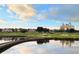 Scenic golf course view featuring lush green fairways, a wooden bridge, and a luxurious building in the background at 314 Muirfield Loop, Reunion, FL 34747