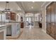 Open-concept kitchen with a center island, stainless steel appliances, and travertine flooring at 314 Muirfield Loop, Reunion, FL 34747