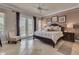 Relaxing bedroom featuring a plush bed, neutral tones, and access to an outdoor space at 314 Muirfield Loop, Reunion, FL 34747