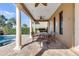 Charming outdoor patio with stone columns and a dining set with cast iron chairs, perfect for alfresco dining at 314 Muirfield Loop, Reunion, FL 34747