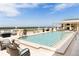 Luxurious rooftop pool with elegant lounge furniture and panoramic views of the surrounding landscape at 314 Muirfield Loop, Reunion, FL 34747