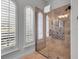 Bright walk-in shower with decorative tile and arched windows providing natural light at 314 Muirfield Loop, Reunion, FL 34747