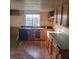 Kitchen with wooden cabinets, a dark countertop, and a view of the outdoors through a window at 31700 Orange St, Sorrento, FL 32776