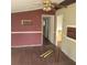 Living room featuring wood floors and a ceiling fan, with visible wall damage at 31700 Orange St, Sorrento, FL 32776