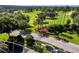 Aerial view of the community entrance shows landscaping and the golf course at 3567 Capland Ave, Clermont, FL 34711