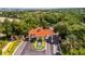 Aerial view of the community gate with fountain and lush landscaping at 3567 Capland Ave, Clermont, FL 34711