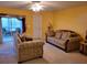 The living room features comfortable sofas and a view of the enclosed porch at 3567 Capland Ave, Clermont, FL 34711