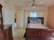 Spacious main bedroom with a ceiling fan and a view of the ensuite bath at 3567 Capland Ave, Clermont, FL 34711