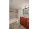 Bathroom featuring tiled shower/tub, wood vanity with granite countertop, and a framed mirror at 385 Wymore Rd # 200, Altamonte Springs, FL 32714