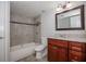 Bathroom featuring tiled shower and tub combination, granite countertop and dark wood vanity at 385 Wymore Rd # 200, Altamonte Springs, FL 32714