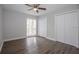 Bedroom with wood-look flooring, ceiling fan, and a large window at 385 Wymore Rd # 200, Altamonte Springs, FL 32714