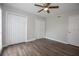 Bedroom with wood-look flooring, ceiling fan, and double closets at 385 Wymore Rd # 200, Altamonte Springs, FL 32714