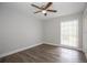 Bedroom with wood-look flooring, ceiling fan, and a large window at 385 Wymore Rd # 200, Altamonte Springs, FL 32714