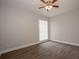 Neutral bedroom featuring a ceiling fan, window with blinds, and wood-look laminate flooring at 385 Wymore Rd # 200, Altamonte Springs, FL 32714