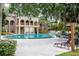 Community pool surrounded by lounge chairs and verdant trees offering a relaxing outdoor space at 385 Wymore Rd # 200, Altamonte Springs, FL 32714