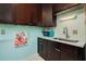 Close-up of the kitchen with dark cabinets, marble countertops, and tiled backsplash at 400 Oakridge Blvd # 5, Daytona Beach, FL 32118