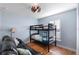 Light and airy bedroom with bunk beds, wood floors, ceiling fan, and a window with plantation shutters at 43 Pergola Pl, Ormond Beach, FL 32174