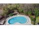 Aerial view of the community pool, surrounded by lounge chairs and lush greenery at 43 Pergola Pl, Ormond Beach, FL 32174