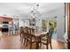 View of the open dining room and kitchen with stainless steel appliances, hardwood floors, and sliding glass doors at 43 Pergola Pl, Ormond Beach, FL 32174