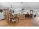 Open floor plan dining room with hardwood floors, chandelier, and a view of the living room and kitchen at 43 Pergola Pl, Ormond Beach, FL 32174