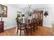 Spacious dining room with hardwood floors, modern chandelier, and a view of the backyard at 43 Pergola Pl, Ormond Beach, FL 32174