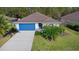 Inviting single-story home with a blue garage door, mature landscaping, and a well-kept lawn at 43 Pergola Pl, Ormond Beach, FL 32174