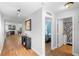 Hallway view with hardwood floors, decorative art, and views of the bedroom and bathroom at 43 Pergola Pl, Ormond Beach, FL 32174