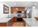 Granite counters in this well-equipped kitchen featuring stainless steel appliances and wood cabinets at 43 Pergola Pl, Ormond Beach, FL 32174